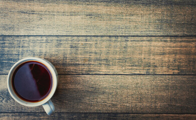 White Cup of hot coffee on a wooden table
