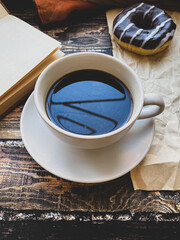 Cup of coffee and chocolate doughnut