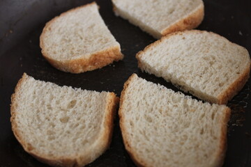 pieces of loaf fried in a pan