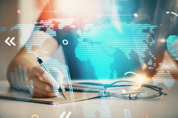 Multi exposure of hands making notes with world map hologram and data theme icons. Concept of global data.