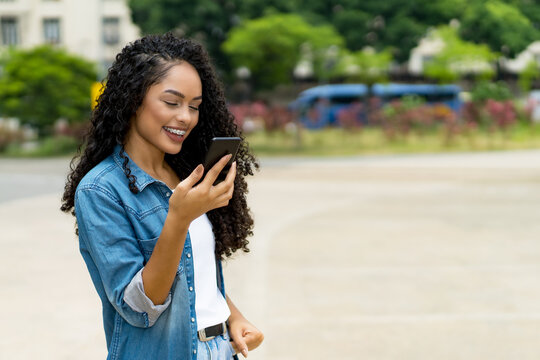 Funny Brazilian Young Adult Woman Using A Smart Phone Voice Recognition