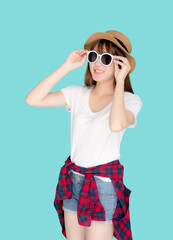 Beautiful portrait young asian woman wear hat and holding sunglasses smiling confident enjoy journey summer trip in vacation isolated on blue background, tourist asia girl cheerful with travel.