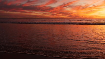 California summertime beach aesthetic, golden sunset. Vivid dramatic clouds over pacific ocean waves. Santa Monica popular resort, Los Angeles CA USA. Atmospheric moody purple evening sundown in LA