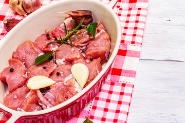 Raw veal cut into pieces with vegetables and other ingredients ready to cook