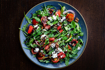 Watermelon and ricotta salad with walnuts, rocket, cherry tomatoes, cucumber and balsamic...