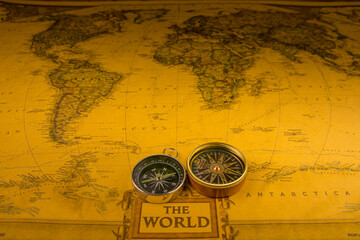 Compasses on old map of the world. Journey and discovery concept