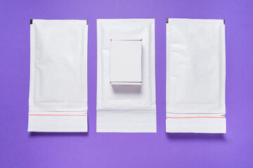 Set of white paper bubble envelopes and carton box for postal shipping