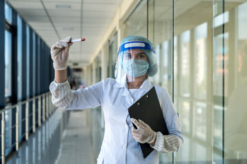 nurse wearing face shield uniform holding positive blood test result for COVID-19
