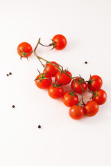 Cherry tomatoes and basil on white background.