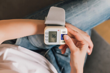 Healthcare and medical concept. Woman measures pressure