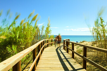 Obraz premium Wooden walkway to the beach in the morning in Alicante, Spain