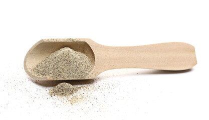 Milled white pepper powder, peppercorn pile with wooden spoon isolated on white background