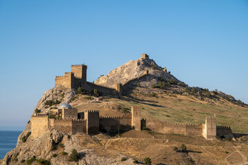 old castle in the mountains against the blue sky, old defensive fortress