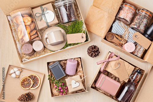 Preparing care package, seasonal gift box with coffee, cookies, candles, spices and cups