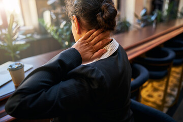 Close up of female hand that touching neck