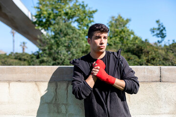 Boxer preparing for training with forearm bandage outside