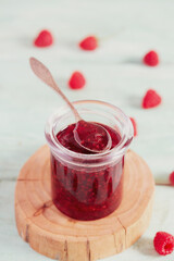 raspberry jam on wooden surface