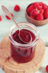 raspberry jam on wooden surface