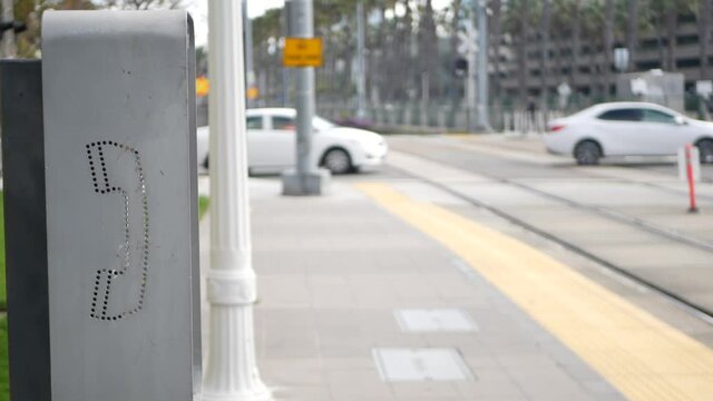Retro coin-operated payphone station for emergency call on street, California USA. Public analog pay phone booth. Outdated technology for connection and telecommunication service. Cell handset on box.