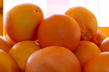 Fresh organic oranges on display on sunny day. Shallow DOF.