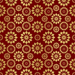 Design on Christmas paper in gold and red. Christmas paper for printing. Gold and red seamless pattern.Gold and red background with Christmas snowflakes.Imitation of metal foil...