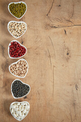 assortment of beans on wooden surface