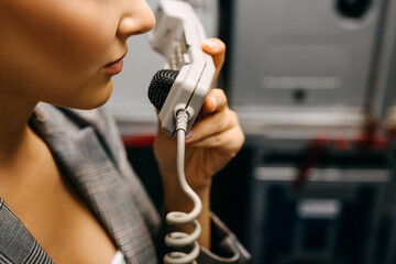Stewardess talking on phone in the airplane, closeup.