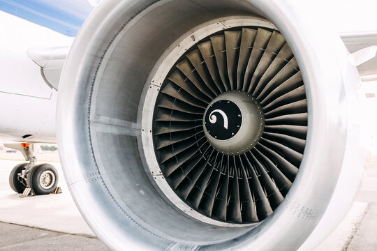 Closeup of an airplane engine on wing.