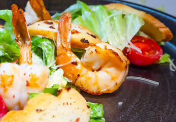 Salad of shrimp, olives, tomato, lettuce and quail eggs. Top viewSelective focus. Super short focus.