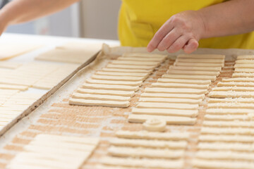 Thinly rolled and cut into strips of dough for crackers.