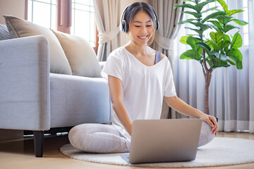 Woman relaxing while use laptop at home.