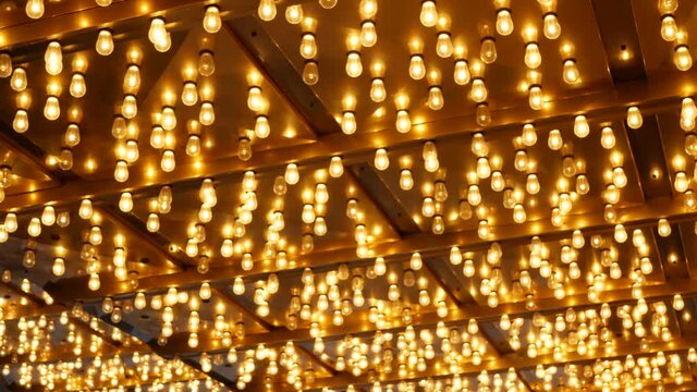 Old fasioned electric lamps blinking and glowing at night. Abstract close up of retro casino decoration shimmering in Las Vegas, USA. Illuminated vintage style bulbs glittering on Freemont street.