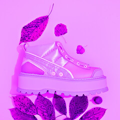 Fashion autumn flat lay shoes sneakers. Minimal fall winter decor. Stylish autumn, winter clothes shopping, sale concept,  creative purple vibes