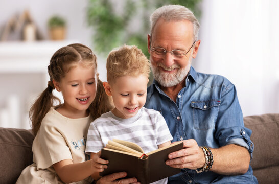 Grandfather reading book to children.