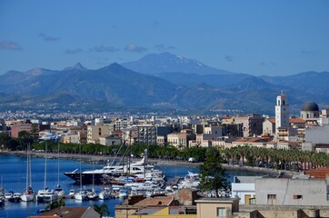Fototapeta na wymiar Milazzo in Sicily with view to the port, etna volcano on horizon, blue sky background