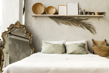 Minimal home interior bedroom design in boho style. Pillows, blanket and decorations. © ribalka yuli