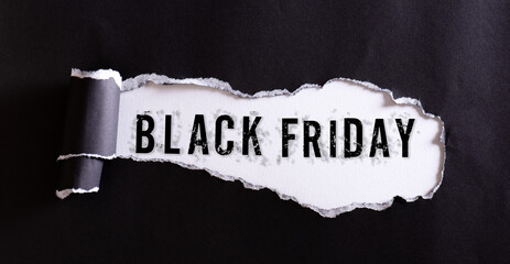 Top view of black torn paper and the text Black Friday on a white background. Black Friday...