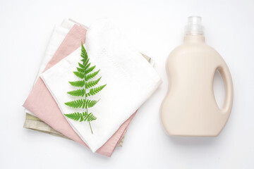 Clean linen napkin and bottle of  laundry detergent. Eco-friendly laundry concept