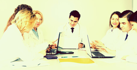 doctors in negotiations in conference room