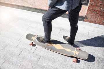 Man in comfortable shoes riding a longboard