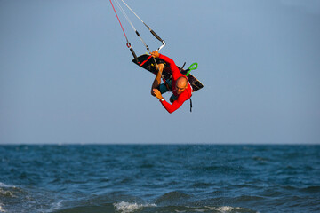 Kitesurfing on the waves of the sea in Mui Ne beach, Phan Thiet, Binh Thuan, Vietnam. Doing the trick - pop