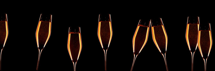 Cheers with golden champagne.
Cheers with golden champagne on black background.
Horizontal close-up for silvester and wedding. Special occasion concept with space for text.