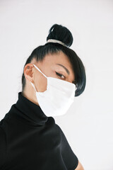 Girl in a white medical mask on a white background