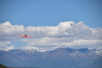Naklejka na ściany i meble The view of mountains with an airplane in Queenstown, New Zealand