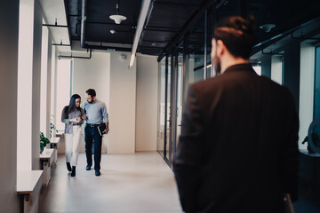 Fototapeta premium Colleagues moving in office lobby