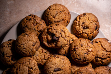 Cookies on a plate with low light. Close-up top view.