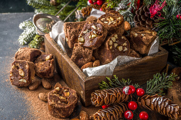 Traditional italian winter and Christmas dessert. Homemade chocolate salami sausage, on festive  background with Christmas decoration