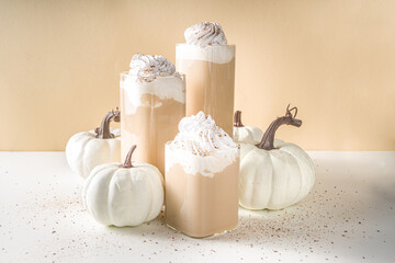 Pumpkin spice latte, with decorative little pumpkins