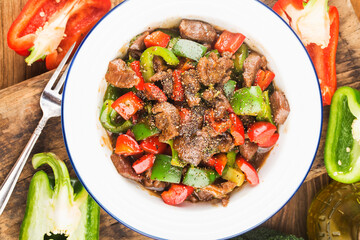 A plate of fried beef cubes with green pepper
