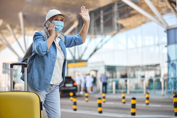Woman with a smartphone flagging a cab